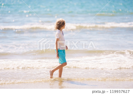 Kids playing on beach. Children play at sea. 119937627