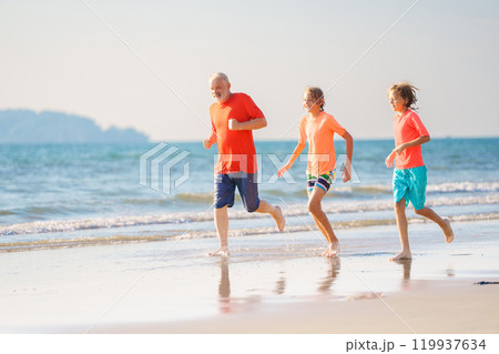Grandfather and kids on summer beach 119937634