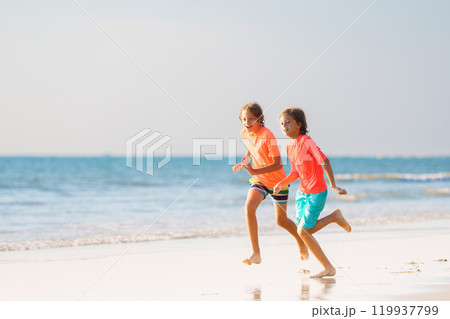 Kids playing on beach. Children play at sea. 119937799