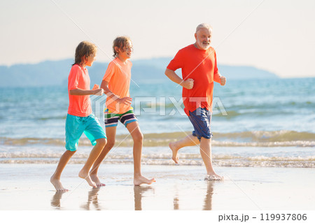 Grandfather and kids on summer beach 119937806