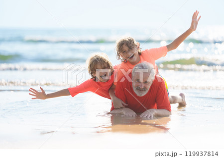 Grandfather and kids on summer beach Grandfather and kids on summer beach 119937814