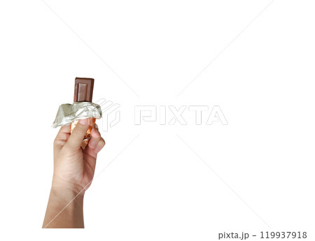 Hand holding brown chocolate bar on white background. Sweet treat in opened package. Hand holding brown chocolate bar on white background. Sweet treat in opened package. 119937918