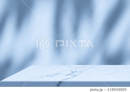 Marble Table Corner with Light Beam, Shadow, and Spotlight on the Blue Concrete Wall Background Marble Table Corner with Light Beam, Shadow, and Spotlight on the Blue Concrete Wall Background 119938005
