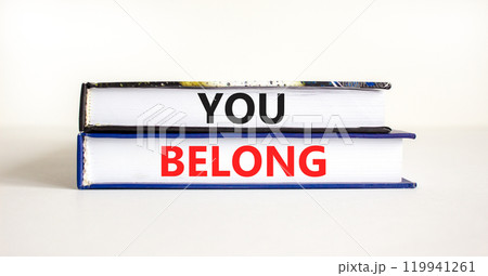 Belonging and you belong symbol. Concept words You belong on beautiful books. Beautiful white background. Business belonging and you belong concept. Copy space. Belonging and you belong symbol. Concept words You belong on beautiful books. Beautiful white background. Business belonging and you belong concept. Copy space. 119941261