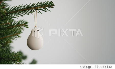 Christmas tree decorative bird close up photo. Christmas winter holiday banner spruce ceramic simple bird plain background and space for text. Banner photo 119943138