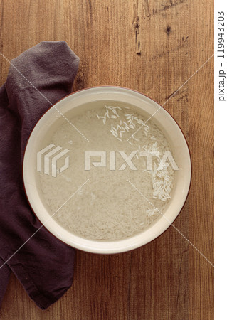 ceramic bowl, with rice soaked in water, raw rice in water, top view, no people, 119943203