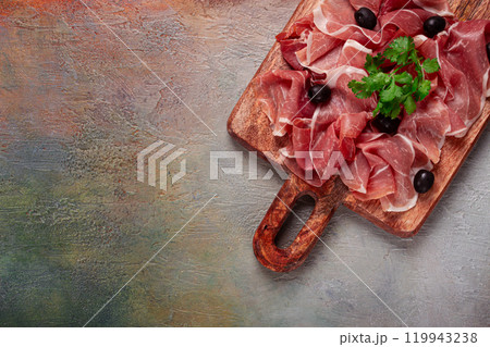 sliced prosciutto, on a cutting board, with olives and herbs, snack, breakfast, no people, sliced prosciutto, on a cutting board, with olives and herbs, snack, breakfast, no people, 119943238