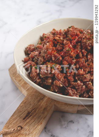 raw minced meat, marinated with spices and herbs, in a bowl, minced meat with spices, top view, homemade, no people, 119943292