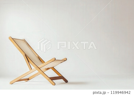 The wooden deck chair stands alone in a minimalist environment, its clean lines and natural materials creating an inviting atmosphere perfect for relaxation. 119946942