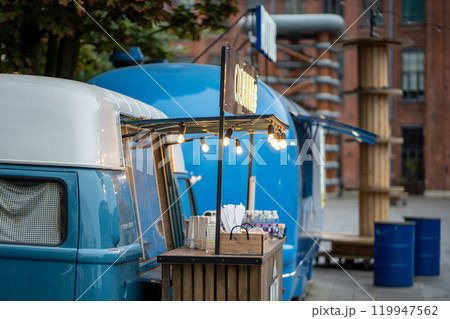 Hot dog van and coffee take away on city street, mobile food truck. Cafe in van with menu outdoors 119947562