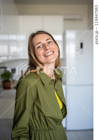 Portrait happy smiling blonde woman looking at camera standing at home having good mood enjoy time. Portrait happy smiling blonde woman looking at camera standing at home having good mood enjoy time. 119947865