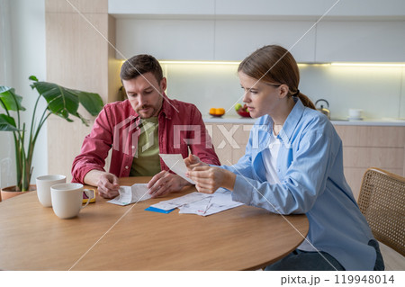 Upset couple review bills, utilities, deal with debts, overdue payments. Poverty, financial issues Upset couple review bills, utilities, deal with debts, overdue payments. Poverty, financial issues 119948014