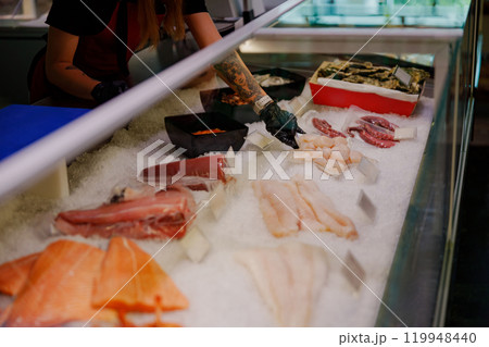 Fresh Seafood Display at a busy market featuring various fish and shellfish ready for selection 119948440