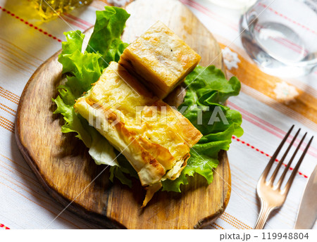 Flija - baked puff pastry with cream or cheese. Served on lettuce leaf. Albanian or Kosovo cuisine Flija - baked puff pastry with cream or cheese. Served on lettuce leaf. Albanian or Kosovo cuisine 119948804