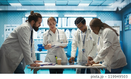 Medical staff collaborates on diagnostic procedures and treatment plans. Radiology specialists work on accurate diagnosis and effective disease prevention, healthcare industry insurance. Camera B. Medical staff collaborates on diagnostic procedures and treatment plans. Radiology specialists work on accurate diagnosis and effective disease prevention, healthcare industry insurance. Camera B. 119949503