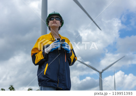 Renewable energy systems concept, engineer female working survey wind turbine for alternative energy, Technology protect environment reduce global warming problems. Renewable energy systems concept, engineer female working survey wind turbine for alternative energy, Technology protect environment reduce global warming problems. 119951393