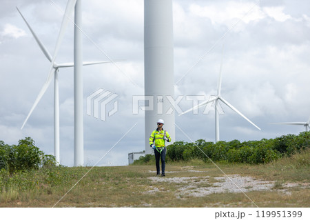Man engineers holding tools box and rope to maintenance working in wind turbine. Renewable energy power wind turbine. Technology protect environment reduce global warming problems 119951399