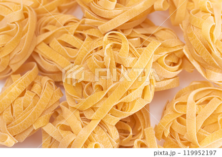 Scattered Classic Italian Raw Egg Fettuccine on White Table Scattered Classic Italian Raw Egg Fettuccine on White Table 119952197