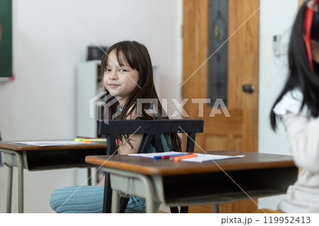 Happy schoolgirl at desk in classroom. Children student girl classroom education in school. Happy schoolgirl at desk in classroom. Children student girl classroom education in school. 119952413