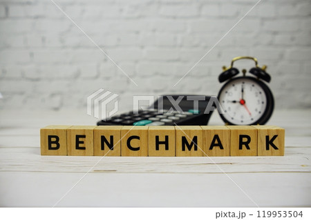 Benchmark with wooden blocks alphabet letters and calculator, alarm clock on Benchmark with wooden blocks alphabet letters and calculator, alarm clock on 119953504