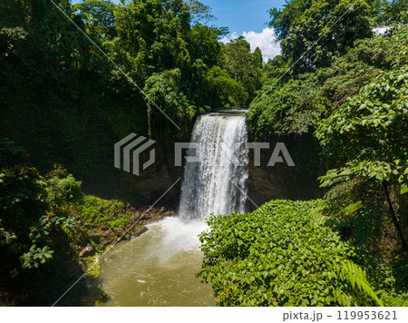 Aerial view of waterfall in Lake Sebu. Falls surrounded by lush vegetation and towering mountains. Mindanao, Philippines. Aerial view of waterfall in Lake Sebu. Falls surrounded by lush vegetation and towering mountains. Mindanao, Philippines. 119953621