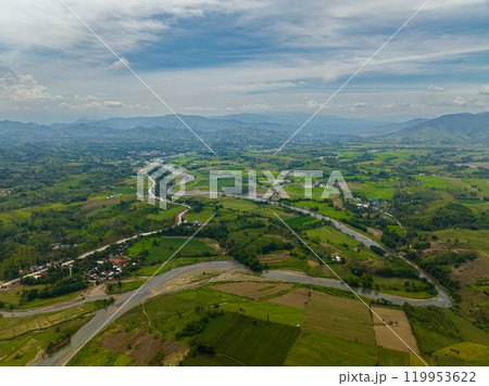 Mountain with hills and green forest. Farmlands and water flowing on river. Mindanao, Philippines. 119953622