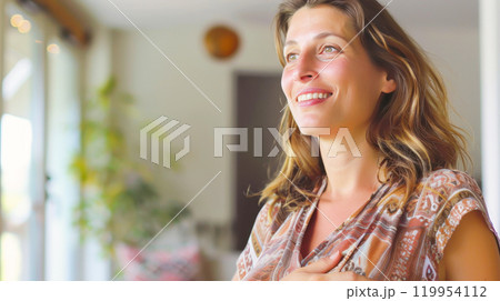 Smiling woman relaxing indoors in natural light 119954112