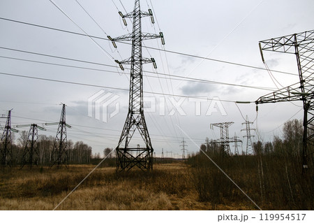 High voltage transmission line supports and wires against a cloudy sky. Power supply High voltage transmission line supports and wires against a cloudy sky. Power supply 119954517