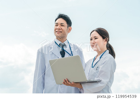 青空と病院で働く白衣を着た医者・医師・ドクター・医療スタッフ 119954539