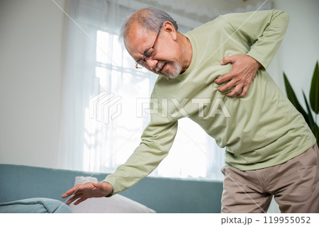 Asian older man have congenital disease suffering from heartache alone at home, Senior man bad pain hand touching chest having heart attack, Old age retirement health problems unhealthy diseased 119955052
