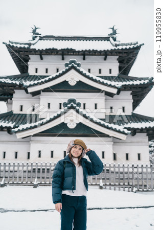 Woman tourist sightseeing Hirosaki Castle in winter, happy traveler travel Hirosaki city, Aomori Prefecture, Tohoku, Japan. Landmark and famous for tourist attraction. Japan travel and vacation Woman tourist sightseeing Hirosaki Castle in winter, happy traveler travel Hirosaki city, Aomori Prefecture, Tohoku, Japan. Landmark and famous for tourist attraction. Japan travel and vacation 119955830