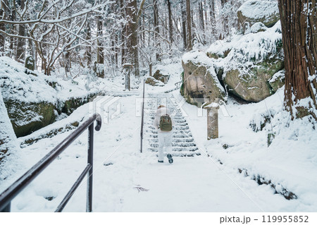 Woman tourist sightseeing Yamadera temple with snow in winter, traveler travel Risshakuji temple in Yamagata City, in Yamagata Prefecture, Tohuku, Japan. Landmark for tourists attraction in Japan 119955852