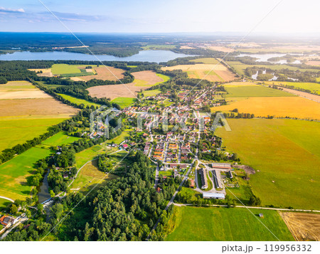 The expansive rural landscape around Trebon showcases patchwork fields, quaint village homes, and serene lakes. This picturesque area highlights the natural beauty and agricultural charm of the Czech 119956332