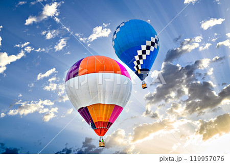 Colorful hot air balloon flying over blue sky with white clouds Colorful hot air balloon flying over blue sky with white clouds 119957076