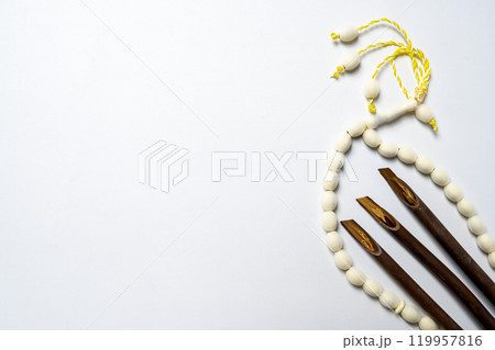 Set of calligraphy reeds and prayer beads isolated over white background 119957816