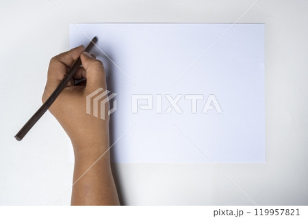 Human hand writing using calligraphy reeds on white paper Human hand writing using calligraphy reeds on white paper 119957821