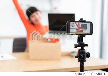 Excited caucasian female blogger unboxing new laptop during live stream 119958081