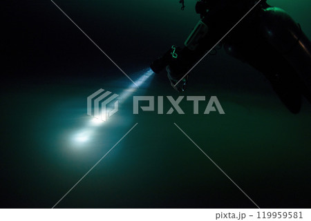 Diving in Mexican Cenote underwater cave with green gas cloud Diving in Mexican Cenote underwater cave with green gas cloud 119959581