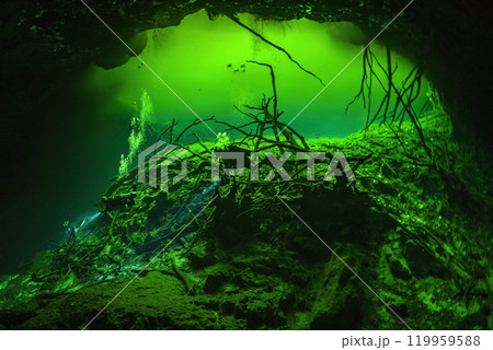 Diving in Mexican Cenote underwater cave with green gas cloud 119959588