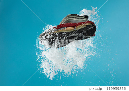 Hiking trail in winter should wear Crampons snow spike on shoes to protect slippery on ice icy surface road. Crampon spike shoe walk good on snow, blue sky background isolated Hiking trail in winter should wear Crampons snow spike on shoes to protect slippery on ice icy surface road. Crampon spike shoe walk good on snow, blue sky background isolated 119959836