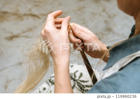 Artisan crafting with natural fibers in a creative workshop setting Artisan crafting with natural fibers in a creative workshop setting 119960236