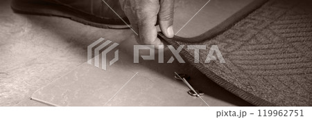 A person getting a key from under their mat 119962751