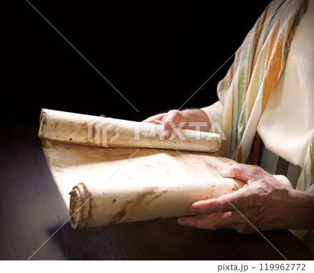 Man's hans holding a scroll 119962772