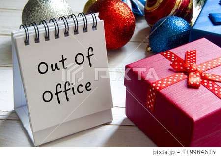 Out Of Office text on white table notepad. Christmas celebration concept Out Of Office text on white table notepad. Christmas celebration concept 119964615
