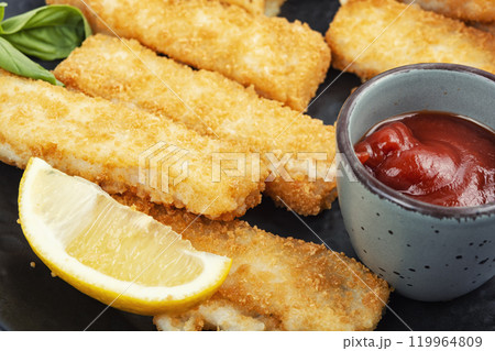 Crispy fish strips with sauce. 119964809
