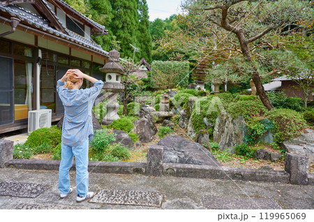 古民家の前で頭を抱える女性　空き家　田舎　相続 119965069
