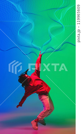Creative design. Dynamic dance of young woman in casual clothes dancing hip hop on gradient blue green background with abstract neon flow elements. Creative design. Dynamic dance of young woman in casual clothes dancing hip hop on gradient blue green background with abstract neon flow elements. 119965609