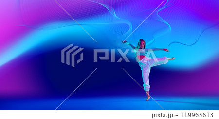 Creative design. Beautiful young woman in casual clothes blending classical ballet movements and modern freestyle dance. Gradient neon background with abstract flow Creative design. Beautiful young woman in casual clothes blending classical ballet movements and modern freestyle dance. Gradient neon background with abstract flow 119965613