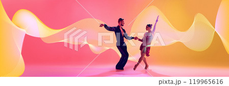 Male and female dancers performing Latin dance in stylish clothes against gradient pink yellow background in neon light with abstract dynamic elements. Male and female dancers performing Latin dance in stylish clothes against gradient pink yellow background in neon light with abstract dynamic elements. 119965616