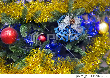 New Year's background. Christmas tree with tinsel toys and bells New Year's background. Christmas tree with tinsel toys and bells 119966207